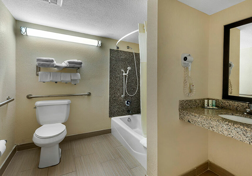 accessible two double beds room bathroom with partial ocean view at Quality Inn Daytona Beach